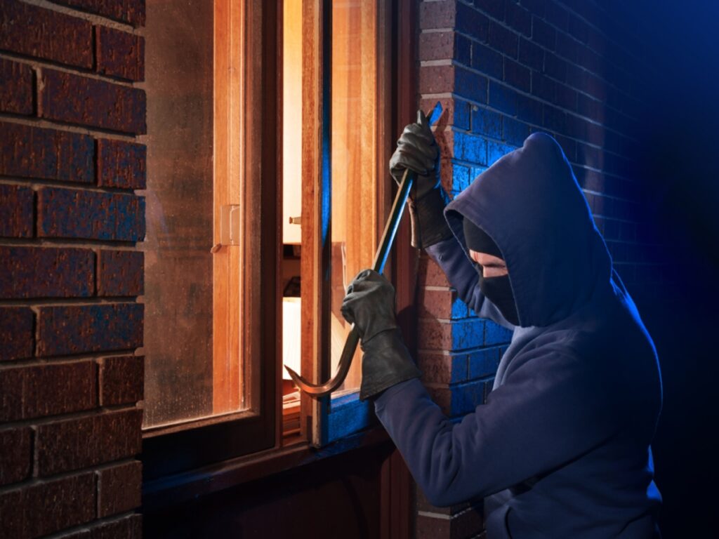 a burglar breaking into a home or apartment with forced entry through a window